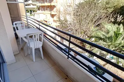 a balcony with a table and chairs on it at HENRI CAMILLE REAL ESTATE - Rouaze 2 -Studio à 50m center in Cannes