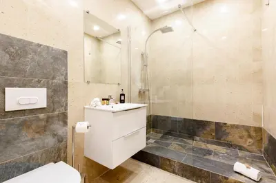 a bathroom with a shower and a toilet and a sink at Gray d'Albion 1D2 YourHostHelper in Cannes
