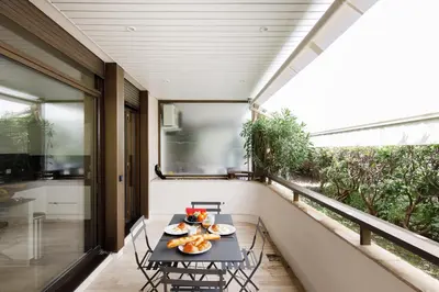 a balcony with a table with food on it at Gray d'Albion 1D2 YourHostHelper in Cannes