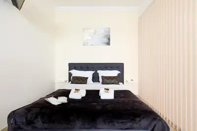 a bedroom with a large bed with black sheets and pillows at Gray d'Albion 1D2 YourHostHelper in Cannes