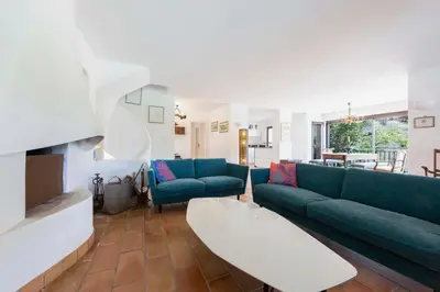a living room with two blue couches and a table at Large Provencal villa with swimming pool in lush greenery LIVE IN CANNES in Vallauris