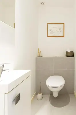 a bathroom with a white toilet and a sink at Large Provencal villa with swimming pool in lush greenery LIVE IN CANNES in Vallauris
