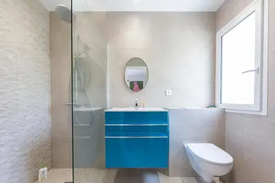a bathroom with a blue sink and a toilet at Large Provencal villa with swimming pool in lush greenery LIVE IN CANNES in Vallauris