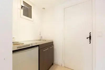 a white kitchen with a sink and a dishwasher at Large Provencal villa with swimming pool in lush greenery LIVE IN CANNES in Vallauris