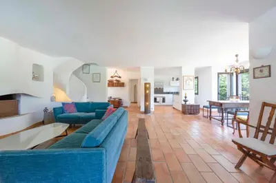 a living room with a blue couch and a table at Large Provencal villa with swimming pool in lush greenery LIVE IN CANNES in Vallauris