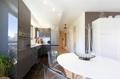 a kitchen with a white table and some chairs at Ideal congress and vacation LIVE IN VILLA PARADOR in Cannes