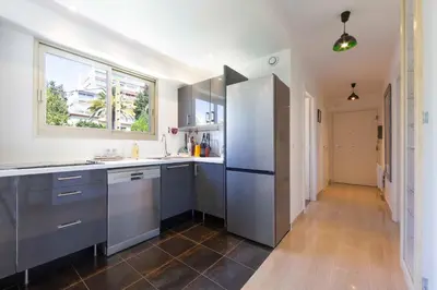 a kitchen with stainless steel appliances and a window at Ideal congress and vacation LIVE IN VILLA PARADOR in Cannes