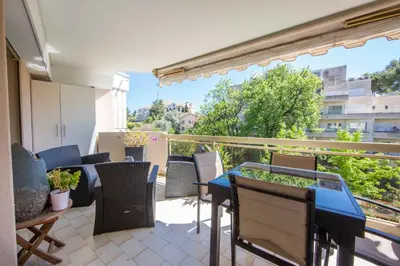 a balcony with a table and chairs and a view at Ideal congress and vacation LIVE IN VILLA PARADOR in Cannes