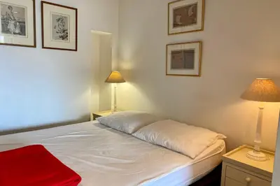 a bedroom with a white bed with two lamps at Cannes Palm Beach Top Floor Terrace ! SAINT JAMES in Cannes