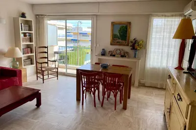 a kitchen with a table and chairs and a dining room at Cannes Palm Beach Top Floor Terrace ! SAINT JAMES in Cannes