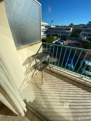 a chair sitting on a balcony with a window at Cannes Palm Beach Top Floor Terrace ! SAINT JAMES in Cannes