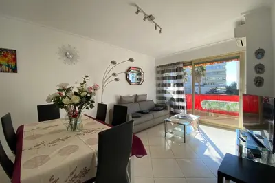 a living room with a table and a couch at 2 rooms facing south 300m from the Croisette LIVE IN LE BOSQUET in Cannes