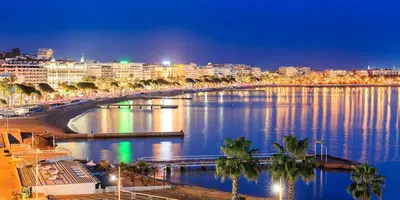 a view of a river with a city at night at 2 rooms facing south 300m from the Croisette LIVE IN LE BOSQUET in Cannes