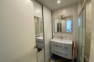a bathroom with a sink and a mirror at 2 rooms facing south 300m from the Croisette LIVE IN LE BOSQUET in Cannes