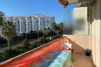 a balcony with a bench and a view of a building at 2 rooms facing south 300m from the Croisette LIVE IN LE BOSQUET in Cannes