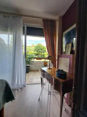 a home office with a desk and a large window at 80m2 dans Parc Classé, Piscine, Calme, 5mn de Cannes in Le Cannet