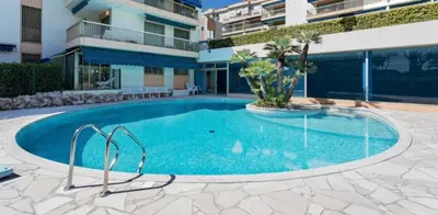 a swimming pool in the middle of a building at Residence Eden park in Cannes