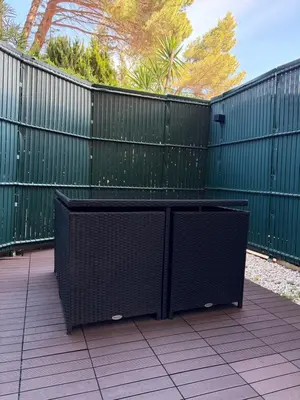 a table and chairs sitting in front of a fence at Residence Eden park in Cannes