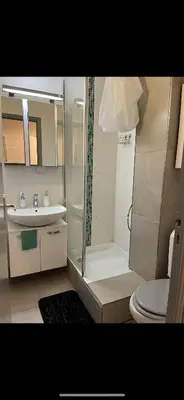 a bathroom with a shower and a toilet and a sink at Residence Eden park in Cannes