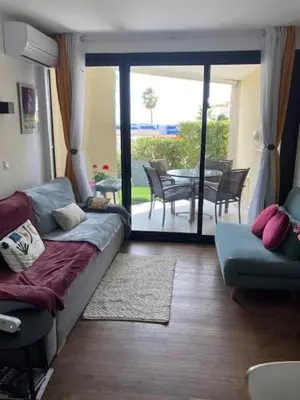 a living room with a couch and a view of a patio at Profitez du Festival du Soleil de Cannes in Cannes