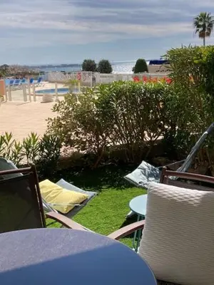 a table and chairs with a view of the beach at Profitez du Festival du Soleil de Cannes in Cannes