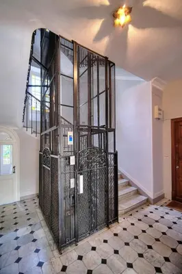 a staircase with a metal gate in a room at IMMOGROOM - Large Apartment - Parking - Air conditioning - Sea view - Wifi in Cannes