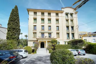 a large building with cars parked in a parking lot at IMMOGROOM - Large Apartment - Parking - Air conditioning - Sea view - Wifi in Cannes