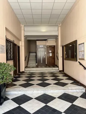 a hallway of a building with a checkered floor at LOENA CANNES CENTRE - 2 pièces rénové - 4 personnes - proche croisette palais festival plage - internet gratuit - climatisation - non fumeur in Cannes