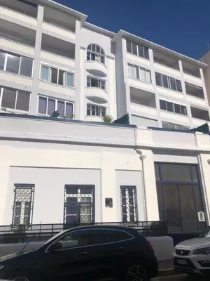a white building with a car parked in front of it at LOENA CANNES CENTRE - 2 pièces rénové - 4 personnes - proche croisette palais festival plage - internet gratuit - climatisation - non fumeur in Cannes