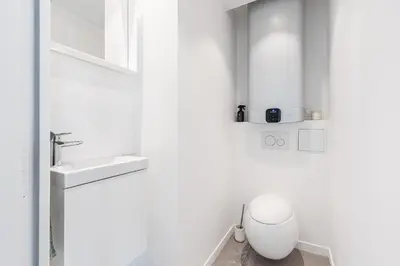 a white bathroom with a sink and a toilet at LUXURIOUS PENTHOUSE ROOFTOP MARTINEZ CROISETTE in Cannes