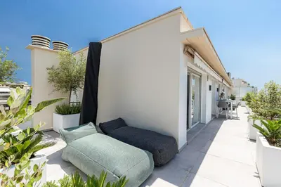 a couch sitting on a patio of a house at LUXURIOUS PENTHOUSE ROOFTOP MARTINEZ CROISETTE in Cannes