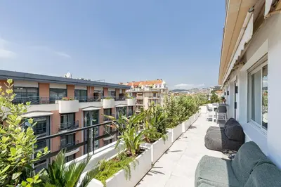 a balcony with chairs and plants on a building at LUXURIOUS PENTHOUSE ROOFTOP MARTINEZ CROISETTE in Cannes