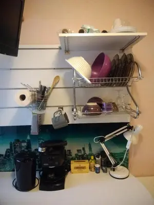 a kitchen counter with a shelf above a sink at Studette Cannes centre in Cannes