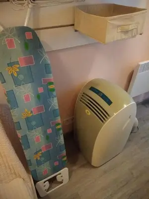 a snowboard leaning up against a wall next to a toaster at Studette Cannes centre in Cannes