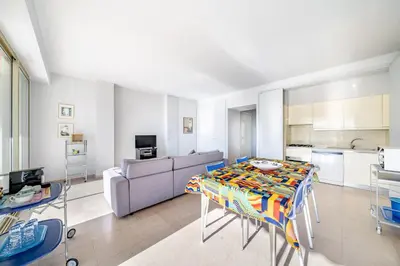 a living room with a table and a couch at Palm beach- Free Wifi- Parking- Sea View in Cannes