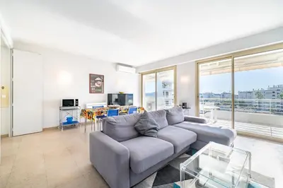 a living room with a couch and a table at Palm beach- Free Wifi- Parking- Sea View in Cannes