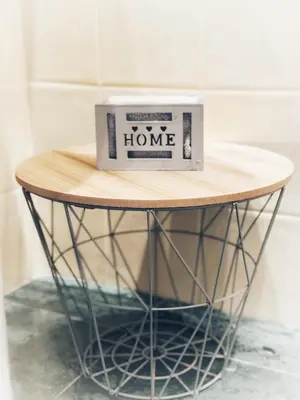 a small round table with a box on it at Palm beach- Free Wifi- Parking- Sea View in Cannes