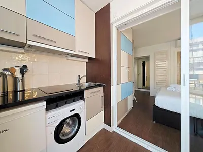 a kitchen with a washer and dryer in a room at Viva Riviera Studio General Ferrié in Cannes
