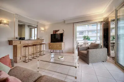 a living room with a couch and a table at IMMOGROOM - 2 BR - Air conditioning - Wifi - Terrace - Common parking in Cannes