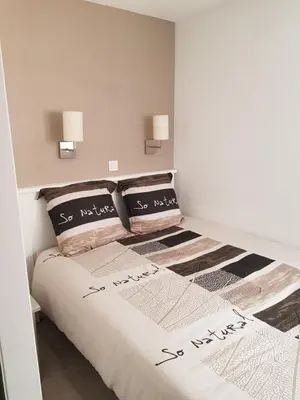 a bedroom with a bed with two pillows on it at Appartement en bord de mer in Cannes