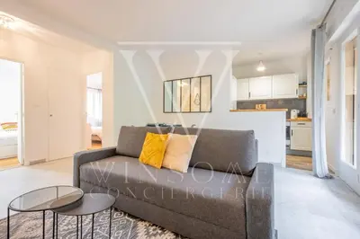 a living room with a couch and a table at Le Smile by Winsome Destination in Cannes