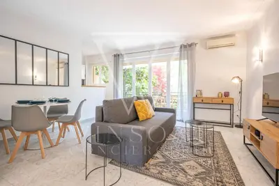 a living room with a couch and a table at Le Smile by Winsome Destination in Cannes