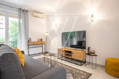 a living room with a couch and a tv at Le Smile by Winsome Destination in Cannes
