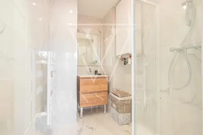 a white bathroom with a shower and a sink at Le Smile by Winsome Destination in Cannes