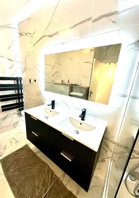 a bathroom with a sink and a mirror at Garden sea view - Victoria - Le Cannet in Le Cannet
