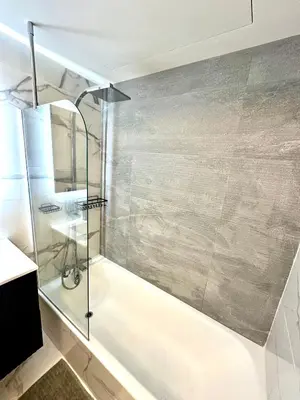 a bathroom with a shower and a bath tub at Garden sea view - Victoria - Le Cannet in Le Cannet