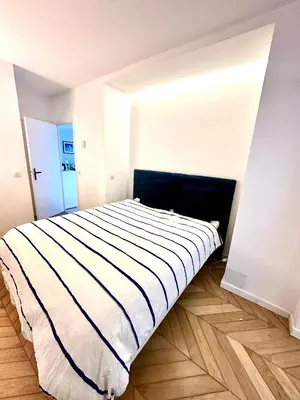 a bedroom with a large bed in a room at Garden sea view - Victoria - Le Cannet in Le Cannet