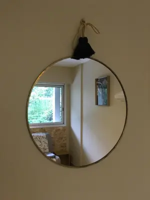 a mirror hanging on a wall in a room at Studette de Cannes in Cannes