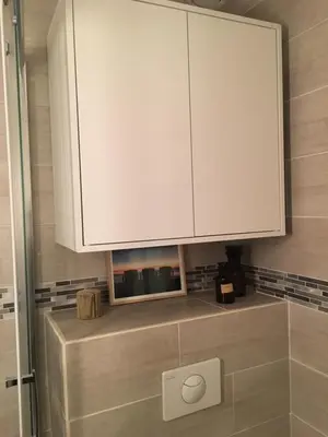 a bathroom with a white cabinet on the wall at Studette de Cannes in Cannes