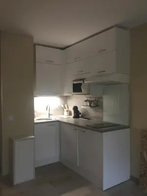 a kitchen with white cabinets and a sink at Studette de Cannes in Cannes